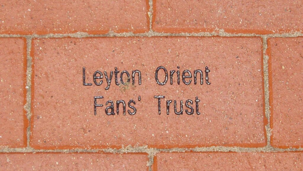 A red brick bearing the words "Leyton Orient Fans' Trust".